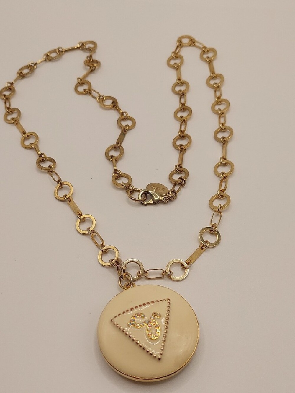 GUESS Blingy AB Gold-Tone Long Pendant Necklace with Cream Enamel Locket - Picture 2 of 14